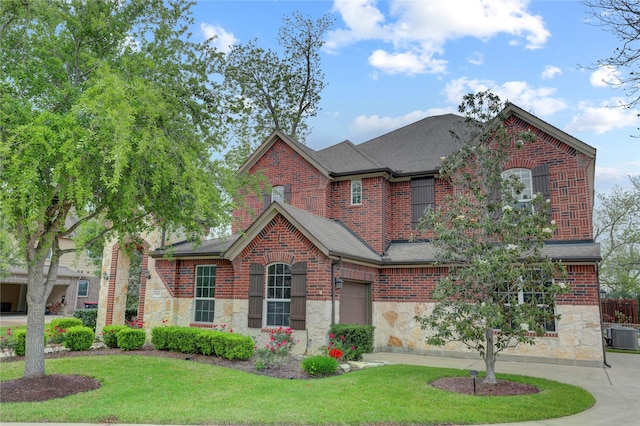 5402 Bending Branch Dr, Missouri City, TX 77459 - view of front of home with stone siding, roof with shingles, a front yard, and cooling unit