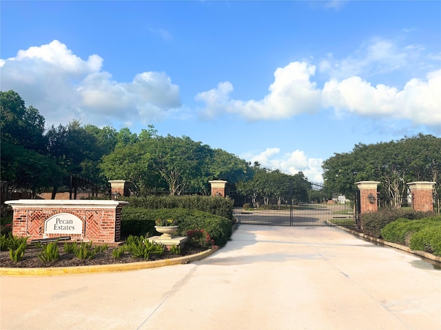 5402 Bending Branch Dr, Missouri City, TX 77459 - view of concrete street with a gate and curbs