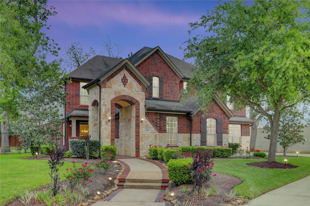 5402 Bending Branch Dr, Missouri City, TX 77459 - view of front of house featuring stone siding, a shingled roof, and brick siding