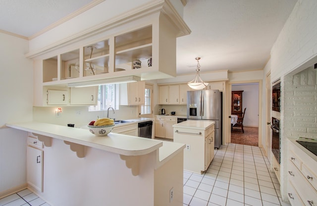 6119 Bankside Dr, Houston, TX 77096 - kitchen with stainless steel appliances, a peninsula, light tile patterned floors, a kitchen island, and light countertops