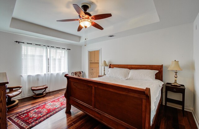 6119 Bankside Dr, Houston, TX 77096 - bedroom with a tray ceiling, dark wood finished floors, and ceiling fan