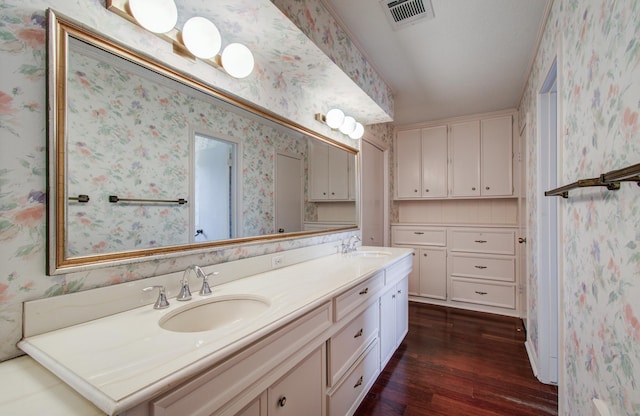 6119 Bankside Dr, Houston, TX 77096 - bathroom with wood finished floors, double vanity, and wallpapered walls