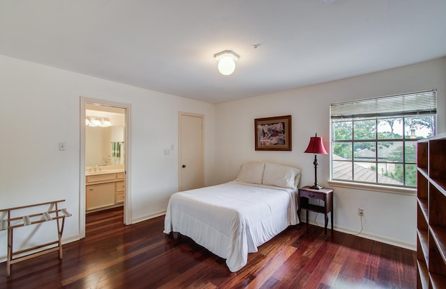 6119 Bankside Dr, Houston, TX 77096 - bedroom with dark wood-style flooring, baseboards, and a sink