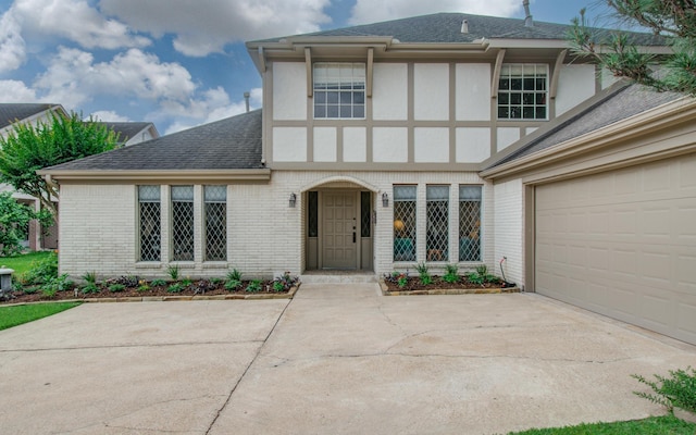 6119 Bankside Dr, Houston, TX 77096 - english style home with a shingled roof, brick siding, driveway, and a garage