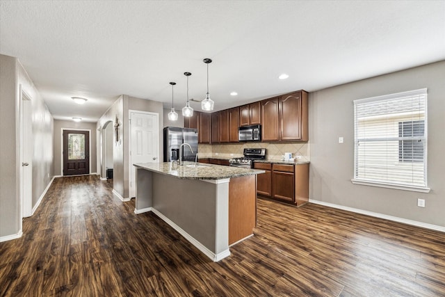 11203 Riata Canyon Dr, Cypress, TX 77433 - kitchen featuring stainless steel appliances, dark wood-type flooring, baseboards, decorative backsplash, and recessed lighting
