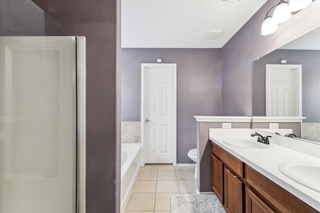 11203 Riata Canyon Dr, Cypress, TX 77433 - bathroom featuring tile patterned flooring, a bath, double vanity, toilet, and an enclosed shower