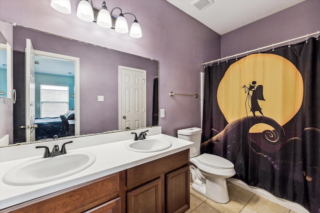 11203 Riata Canyon Dr, Cypress, TX 77433 - ensuite bathroom with tile patterned floors, double vanity, toilet, and curtained shower
