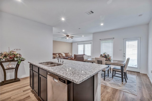 15007 Ashton Meadows Dr, New Caney, TX 77357 - kitchen featuring stainless steel dishwasher, a sink, light stone countertops, light wood finished floors, and recessed lighting