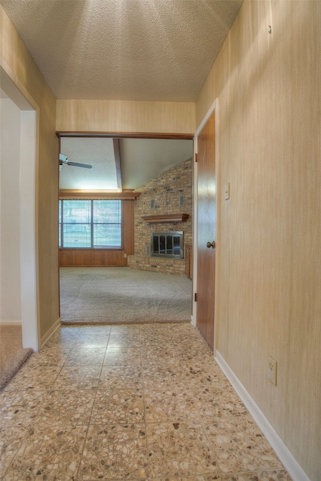 333 Hardy St, Huntsville, TX 77340 - unfurnished living room with a fireplace, a textured ceiling, carpet, and a ceiling fan