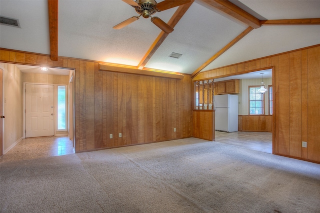 333 Hardy St, Huntsville, TX 77340 - unfurnished living room featuring wooden walls, light carpet, and a ceiling fan