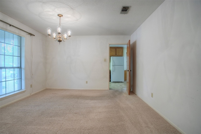 333 Hardy St, Huntsville, TX 77340 - spare room with a chandelier, carpet flooring, and baseboards