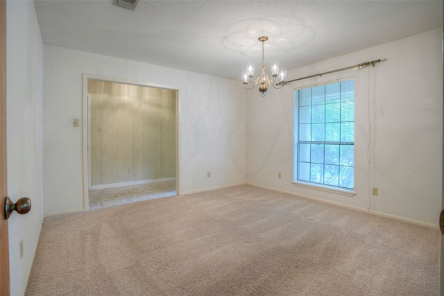 333 Hardy St, Huntsville, TX 77340 - spare room featuring a chandelier, carpet flooring, and baseboards