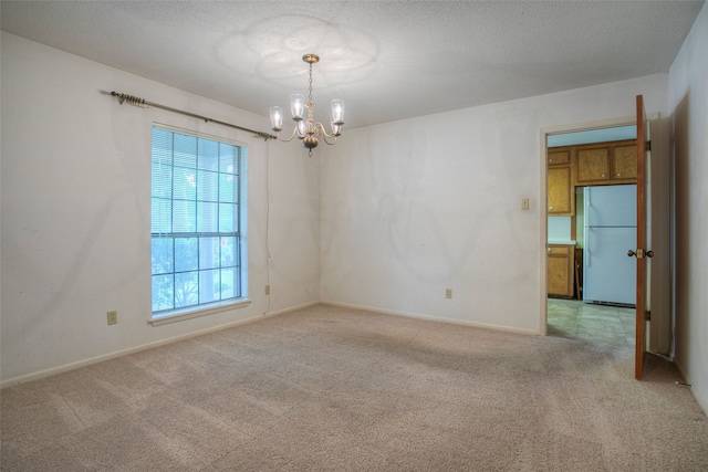 333 Hardy St, Huntsville, TX 77340 - spare room featuring a chandelier, light carpet, and baseboards