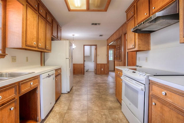 333 Hardy St, Huntsville, TX 77340 - kitchen with white appliances, under cabinet range hood, brown cabinets, light countertops, and wallpapered walls