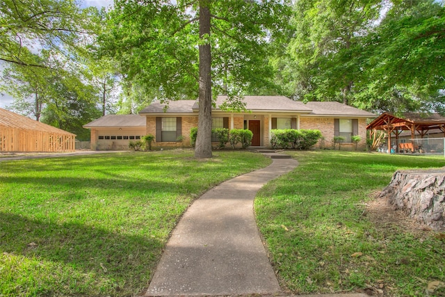 333 Hardy St, Huntsville, TX 77340 - ranch-style house with a front yard, brick siding, a gazebo, and a garage
