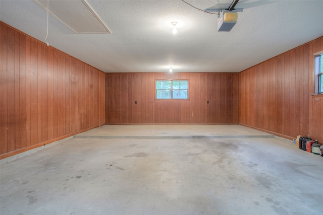 333 Hardy St, Huntsville, TX 77340 - garage featuring wood walls and a garage door opener