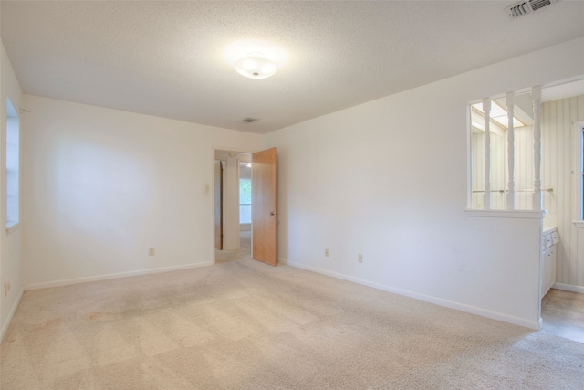 333 Hardy St, Huntsville, TX 77340 - unfurnished room featuring light colored carpet, baseboards, and a textured ceiling