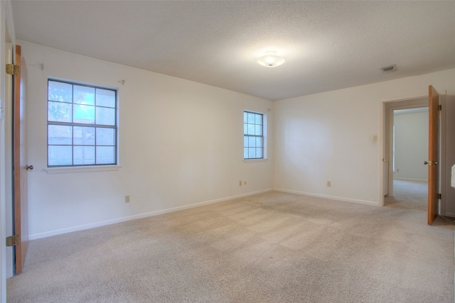 333 Hardy St, Huntsville, TX 77340 - empty room with light carpet, baseboards, and a textured ceiling