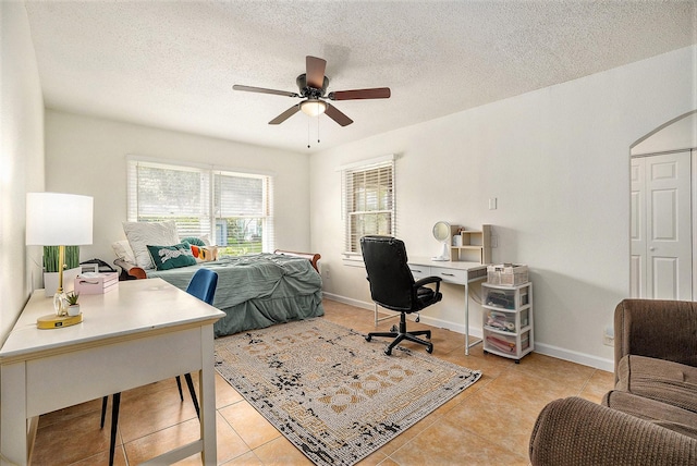 116 Whiting St, Galveston, TX 77550 - bedroom featuring a desk, light tile patterned floors, a textured ceiling, ceiling fan, and baseboards