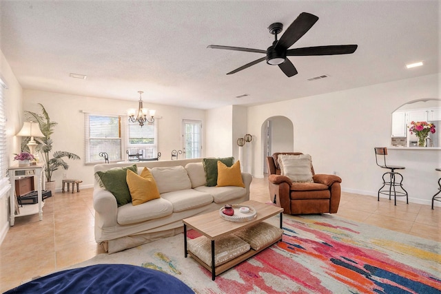 116 Whiting St, Galveston, TX 77550 - living room featuring light tile patterned floors, ceiling fan, a chandelier, arched walkways, and baseboards