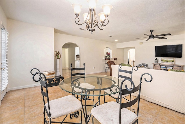 116 Whiting St, Galveston, TX 77550 - dining area featuring arched walkways, light tile patterned flooring, ceiling fan, a chandelier, and a textured ceiling