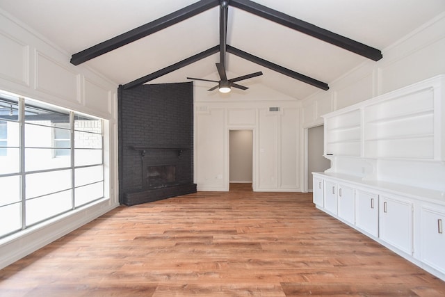 4618 Turf Valley Dr, Houston, TX 77084 - unfurnished living room with a decorative wall, a ceiling fan, a brick fireplace, and light wood-type flooring