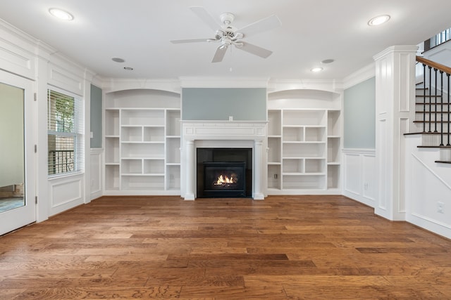 1510 Marshall St, Houston, TX 77006 - unfurnished living room with wood finished floors, stairs, a decorative wall, ceiling fan, and a glass covered fireplace