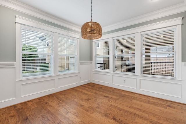 1510 Marshall St, Houston, TX 77006 - unfurnished dining area with ornamental molding, a decorative wall, wood finished floors, and wainscoting