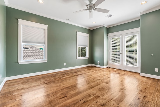 1510 Marshall St, Houston, TX 77006 - spare room with healthy amount of natural light, wood finished floors, french doors, baseboards, and crown molding