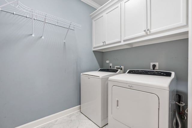 1510 Marshall St, Houston, TX 77006 - laundry area with light marble finish floors, cabinet space, separate washer and dryer, and baseboards