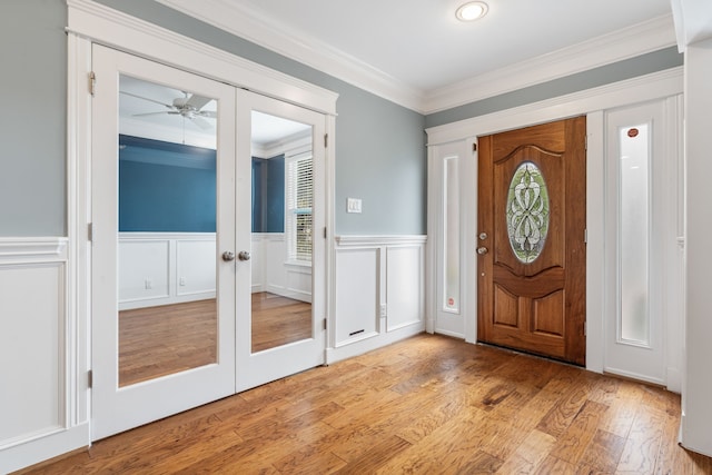1510 Marshall St, Houston, TX 77006 - entryway featuring french doors, ornamental molding, light wood-style floors, wainscoting, and a ceiling fan