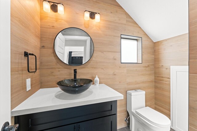10070 Cedardale Dr, Houston, TX 77055 - bathroom featuring vanity, lofted ceiling, and toilet