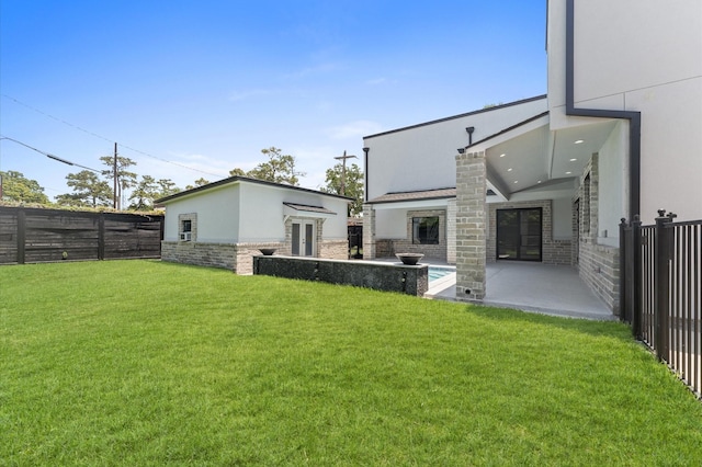10070 Cedardale Dr, Houston, TX 77055 - rear view of house with french doors, stone siding, a patio area, and stucco siding