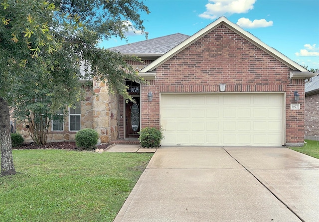 1027 Nantucket St, Pasadena, TX 77503 - view of front facade featuring driveway, a front yard, a garage, and brick siding