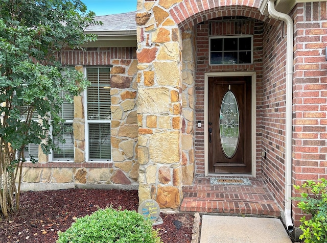 1027 Nantucket St, Pasadena, TX 77503 - doorway to property featuring brick siding and roof with shingles