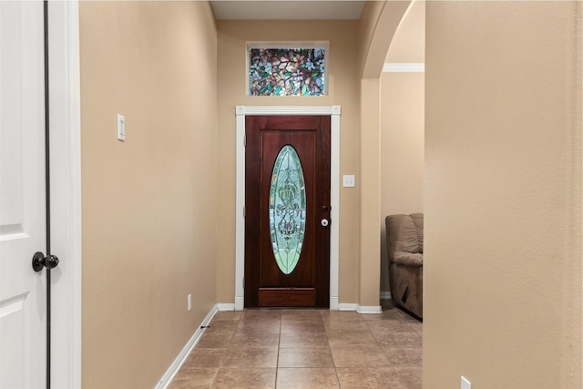 1027 Nantucket St, Pasadena, TX 77503 - foyer with baseboards, arched walkways, and light tile patterned flooring