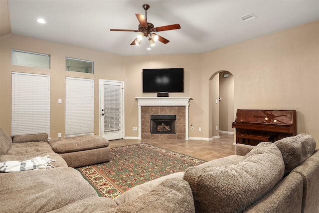 1027 Nantucket St, Pasadena, TX 77503 - tiled living area with arched walkways, a ceiling fan, baseboards, a fireplace, and recessed lighting