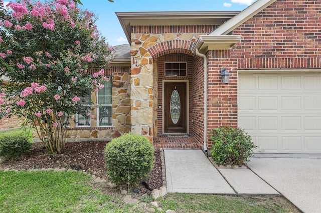 1027 Nantucket St, Pasadena, TX 77503 - doorway to property featuring an attached garage and brick siding