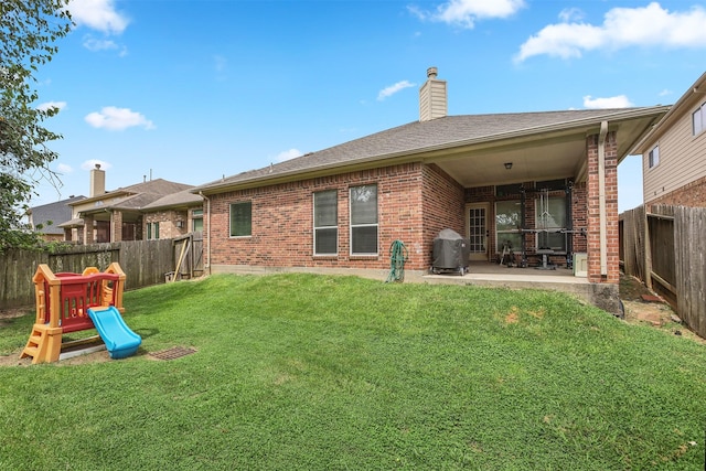 1027 Nantucket St, Pasadena, TX 77503 - back of property featuring brick siding, a patio area, a fenced backyard, a chimney, and a playground