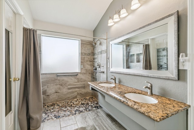19119 Mossy Hedge Ln, Katy, TX 77449 - full bath with a tile shower, double vanity, and vaulted ceiling