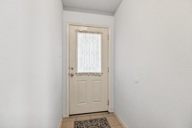 19119 Mossy Hedge Ln, Katy, TX 77449 - doorway to outside featuring baseboards and light tile patterned flooring
