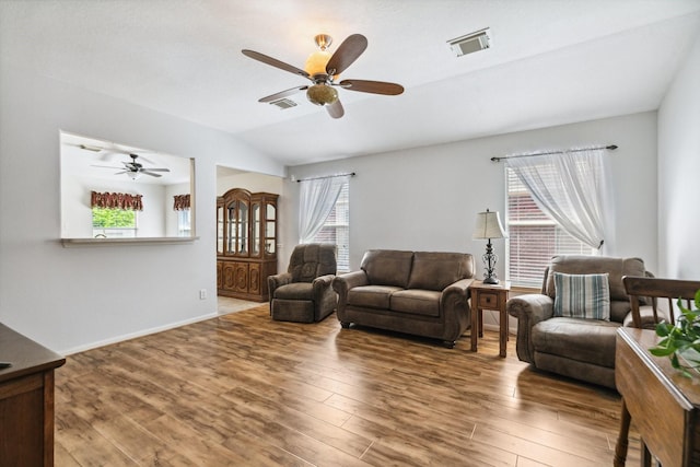 19119 Mossy Hedge Ln, Katy, TX 77449 - living room with ceiling fan, lofted ceiling, wood finished floors, and baseboards