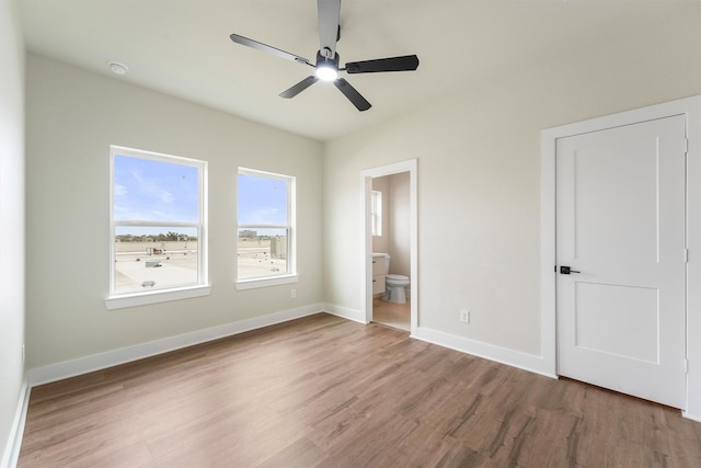 1932 Purswell Rd, Houston, TX 77055 - unfurnished bedroom featuring wood finished floors, baseboards, ensuite bath, and ceiling fan