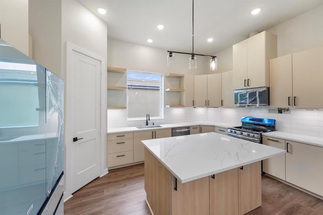 1932 Purswell Rd, Houston, TX 77055 - kitchen with a sink, stainless steel appliances, open shelves, light wood-style floors, and a center island