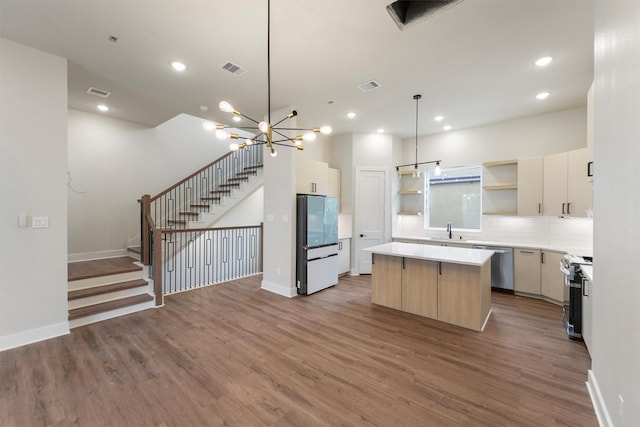 1932 Purswell Rd, Houston, TX 77055 - kitchen with appliances with stainless steel finishes, open shelves, a sink, a kitchen island, and wood finished floors