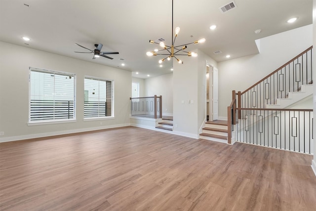 1932 Purswell Rd, Houston, TX 77055 - unfurnished living room featuring wood finished floors, stairway, ceiling fan, a chandelier, and recessed lighting