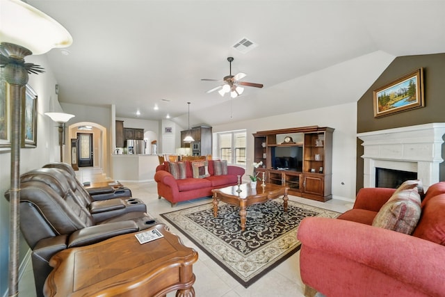 20688 Oakhurst Meadows Dr, Porter, TX 77365 - living room with ceiling fan, a high end fireplace, vaulted ceiling, light tile patterned floors, and baseboards