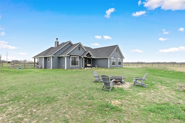 12078 County Road 175, Iola, TX 77861 - back of property featuring a chimney, an outdoor fire pit, cooling unit, and board and batten siding