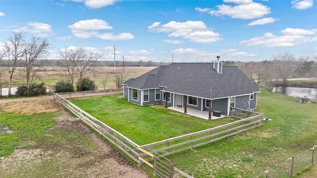12078 County Road 175, Iola, TX 77861 - back of property featuring a patio area, a shingled roof, a chimney, and a view of rural / pastoral area