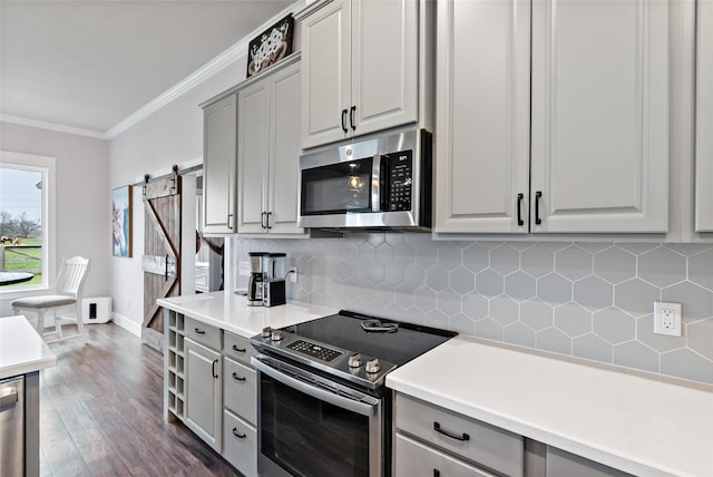 12078 County Road 175, Iola, TX 77861 - kitchen featuring appliances with stainless steel finishes, gray cabinetry, ornamental molding, and tasteful backsplash